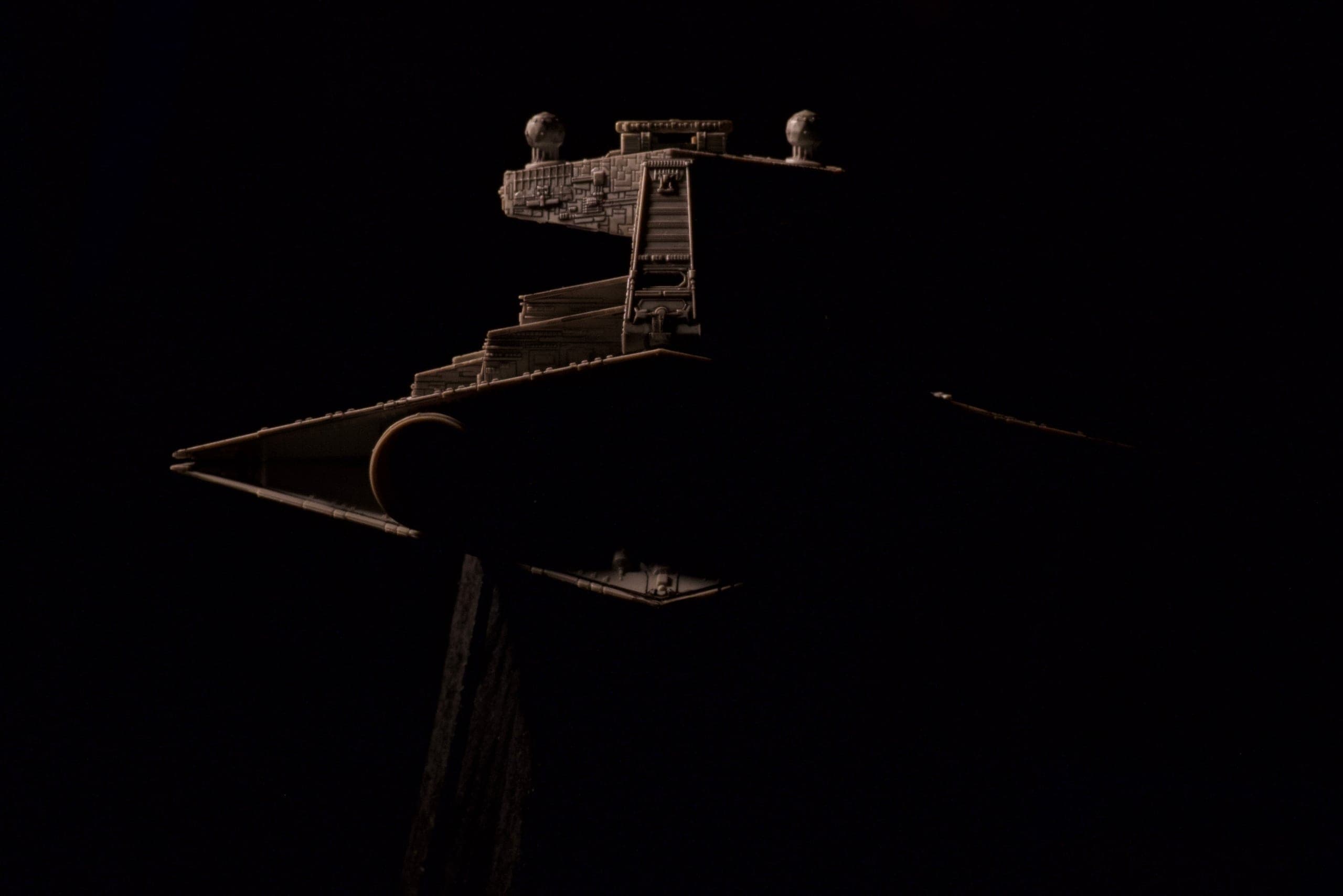 Bridge tower of the miniature as a silhouette against the dark workshop